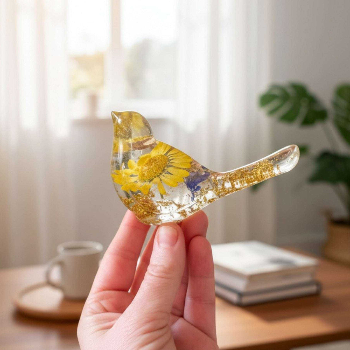 Handcrafted yellow floral resin bird with a real yellow daisy and gold leaf