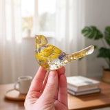 Handcrafted yellow floral resin bird with a real yellow daisy and gold leaf