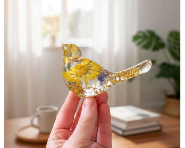 Handcrafted yellow floral resin bird with a real yellow daisy and gold leaf