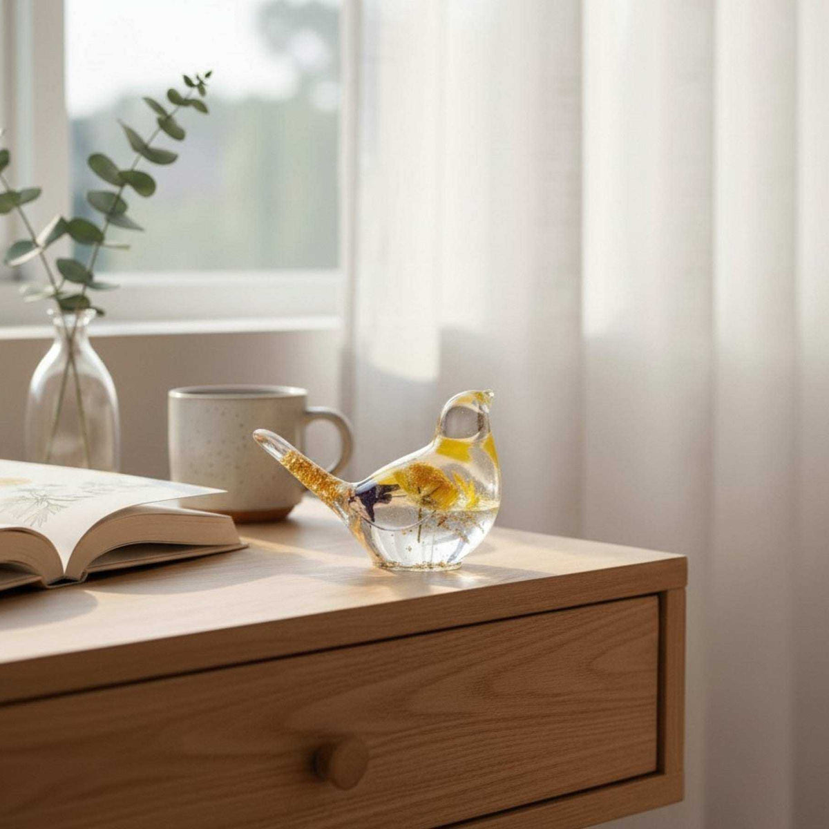 Handcrafted yellow floral resin bird with a real yellow daisy and gold leaf