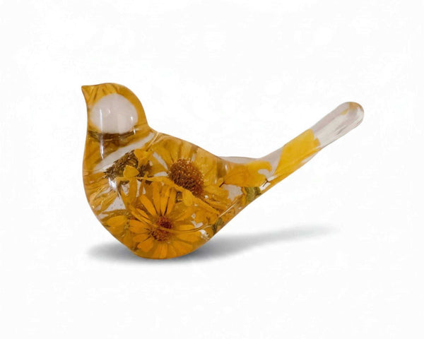 Yellow floral resin bird with pressed golden daisies and foliage in glossy amber resin, featuring a clear head and tail.