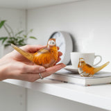 Golden strawflower resin bird pair with preserved yellow blooms and gold leaf shimmer